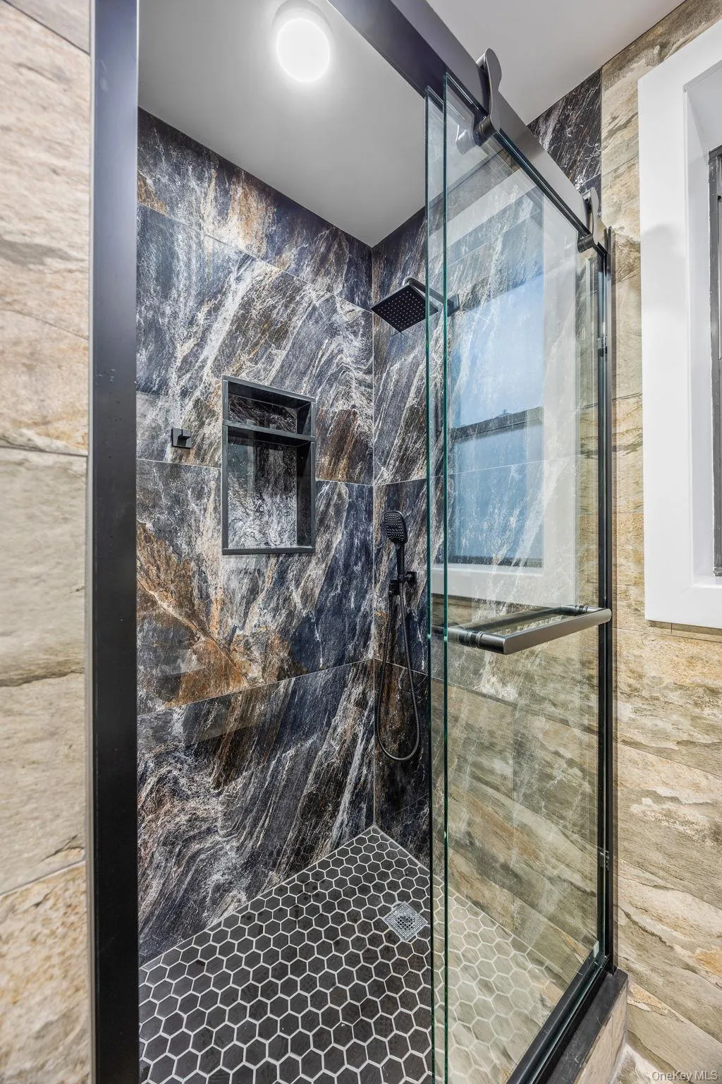 Full bathroom featuring a marble finish shower Full bathroom featuring a marble finish shower