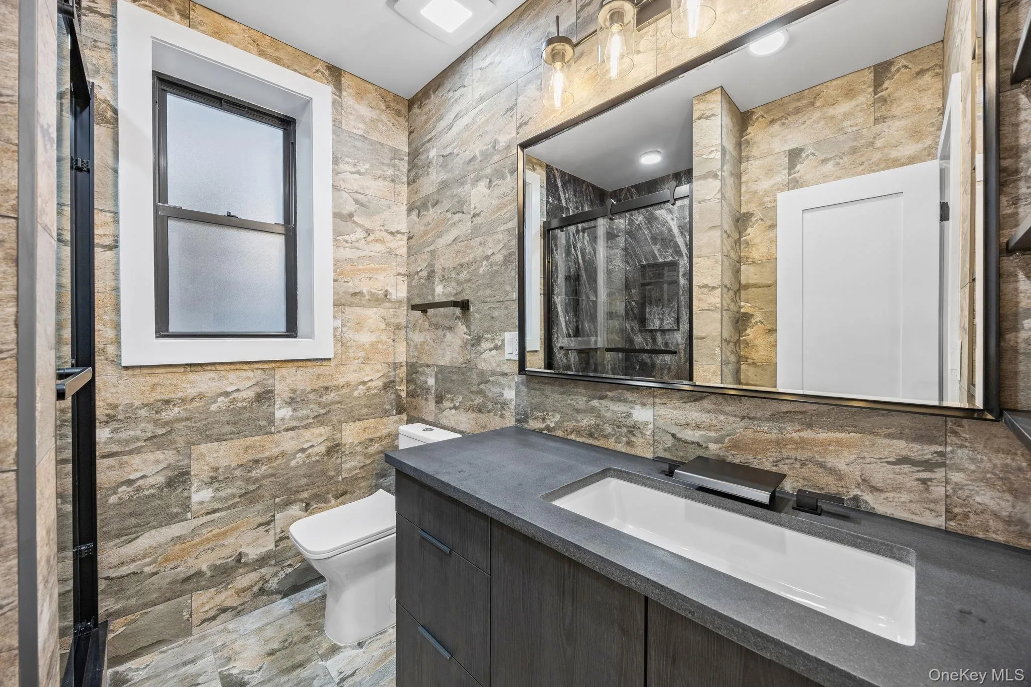 Bathroom featuring a stall shower and vanity Bathroom featuring a stall shower and vanity