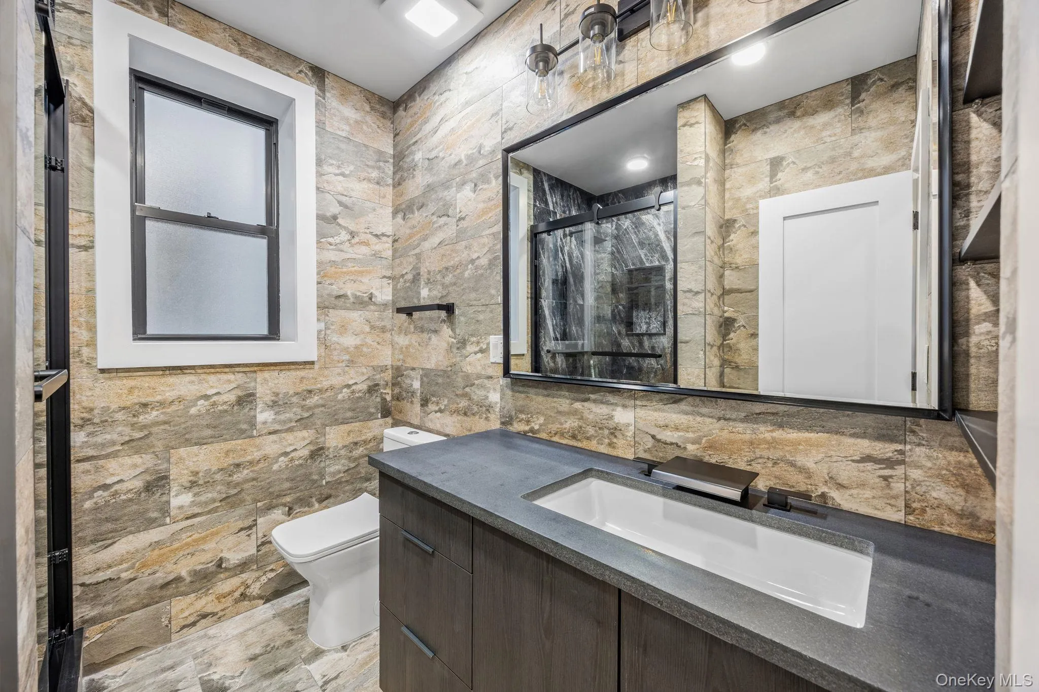 Full bathroom with a shower stall and vanity Full bathroom with a shower stall and vanity