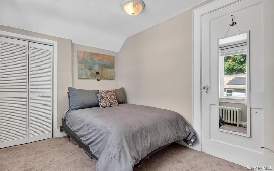 Carpeted bedroom with large closet and plenty of windows Carpeted bedroom with large closet and plenty of windows