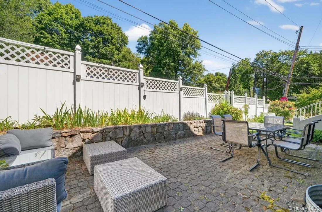 Fenced yard with a patio area, outdoor dining space, and an outdoor living space Fenced yard with a patio area, outdoor dining space, and an outdoor living space