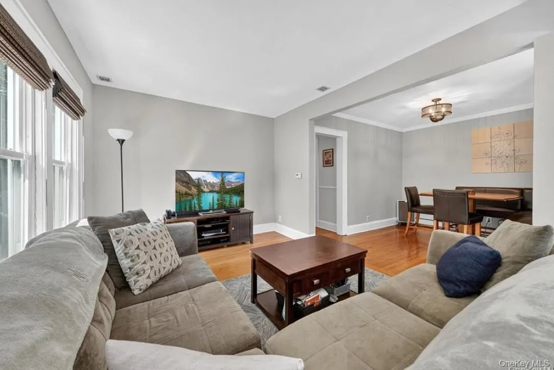 The open plan Living/dining area with hardwood floors and plenty of windows The open plan Living/dining area with hardwood floors and plenty of windows