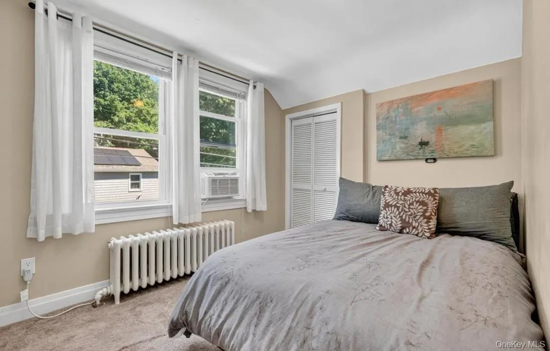 Second floor bedroom with vaulted ceiling, and wall of windows Second floor bedroom with vaulted ceiling, and wall of windows