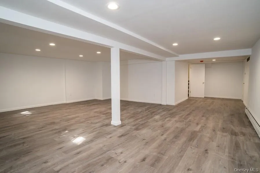 Finished below grade area featuring recessed lighting and wood finished floors Finished below grade area featuring recessed lighting and wood finished floors