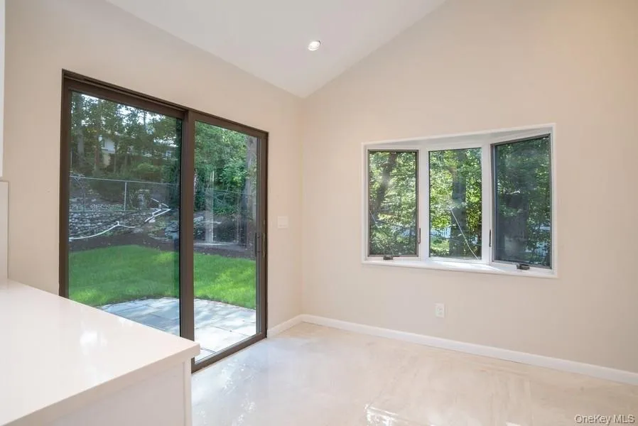 Doorway with vaulted ceiling, plenty of natural light, and recessed lighting Doorway with vaulted ceiling, plenty of natural light, and recessed lighting