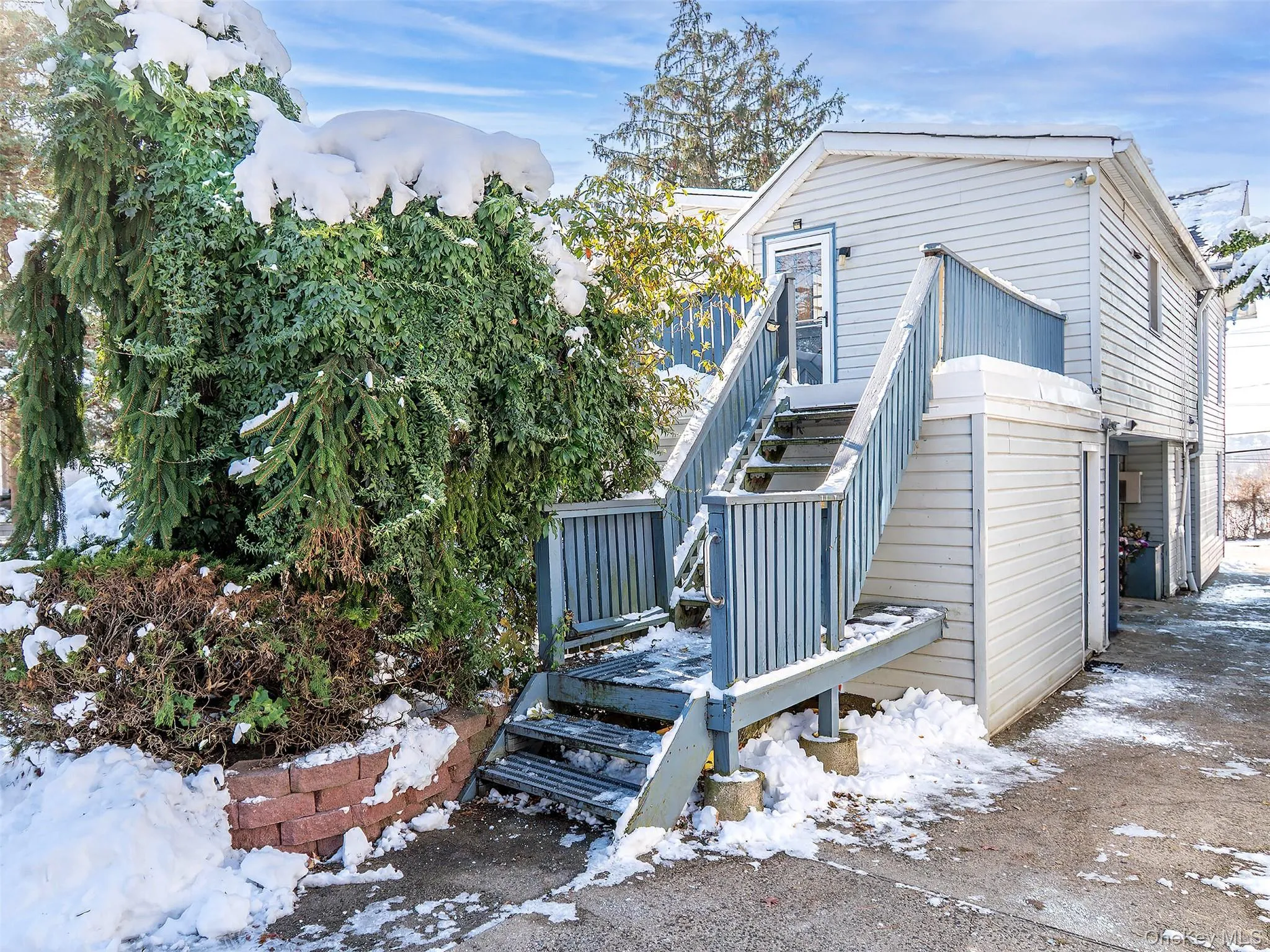 View of snow covered exterior with stairs View of snow covered exterior with stairs