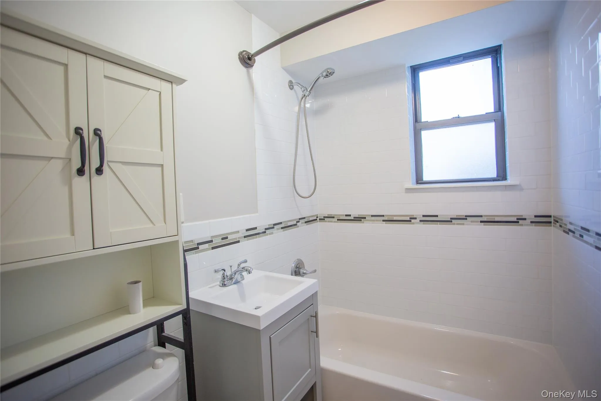 Bathroom featuring washtub / shower combination and vanity Bathroom featuring washtub / shower combination and vanity