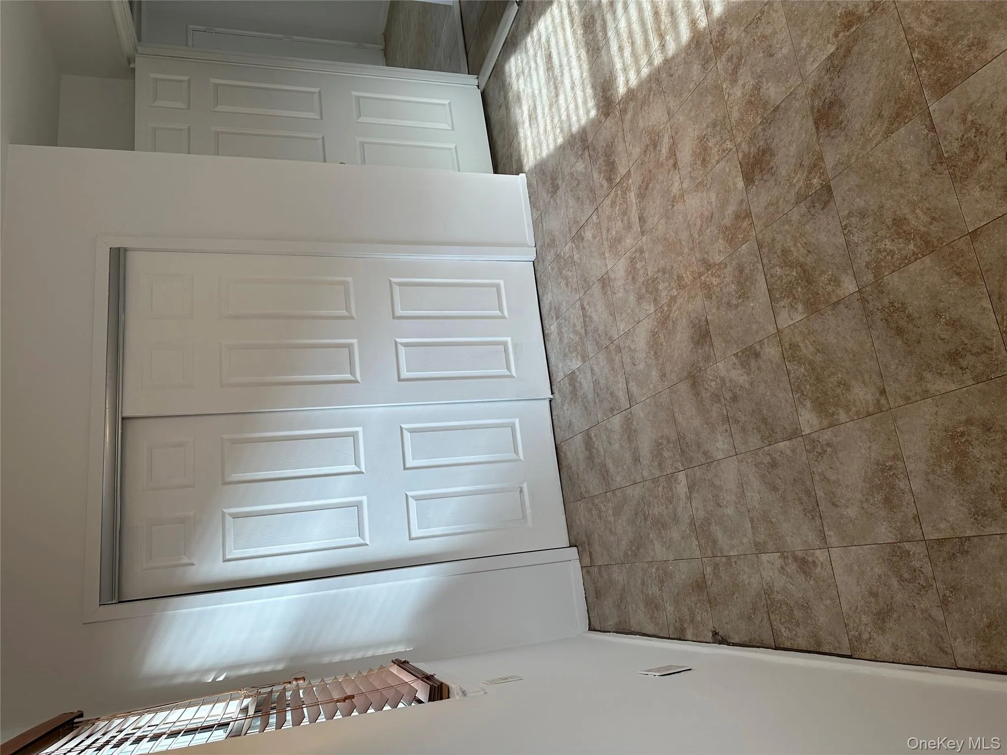 Unfurnished bedroom featuring a closet and tile patterned floors Unfurnished bedroom featuring a closet and tile patterned floors