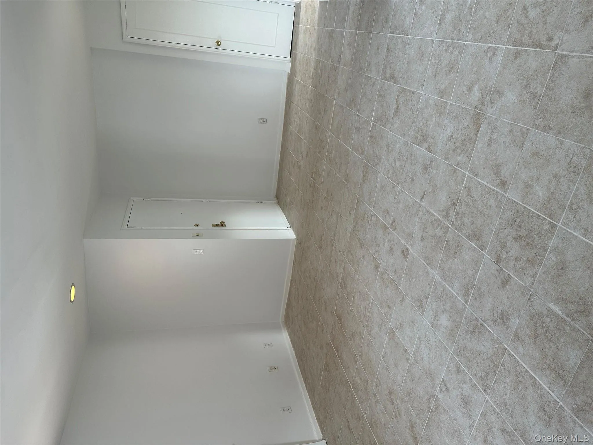 Spare room featuring baseboards and light tile patterned flooring Spare room featuring baseboards and light tile patterned flooring