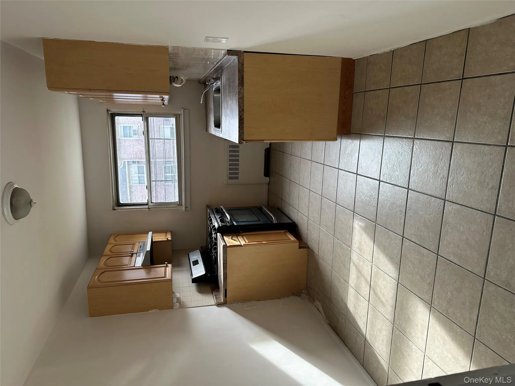 Kitchen with backsplash, stove, radiator heating unit, and extractor fan Kitchen with backsplash, stove, radiator heating unit, and extractor fan