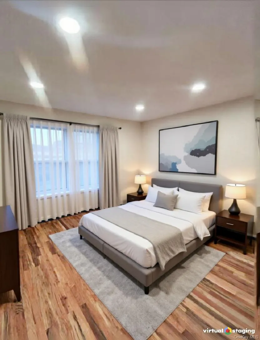 Bedroom with light wood-type flooring and recessed lighting Bedroom with light wood-type flooring and recessed lighting