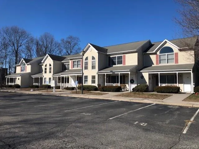 View of front of home with a residential view, a porch, and uncovered parking View of front of home with a residential view, a porch, and uncovered parking