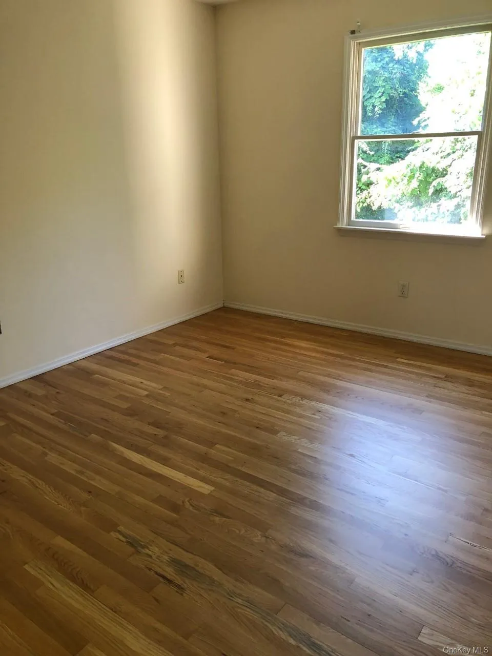Empty room featuring dark wood-type flooring Empty room featuring dark wood-type flooring