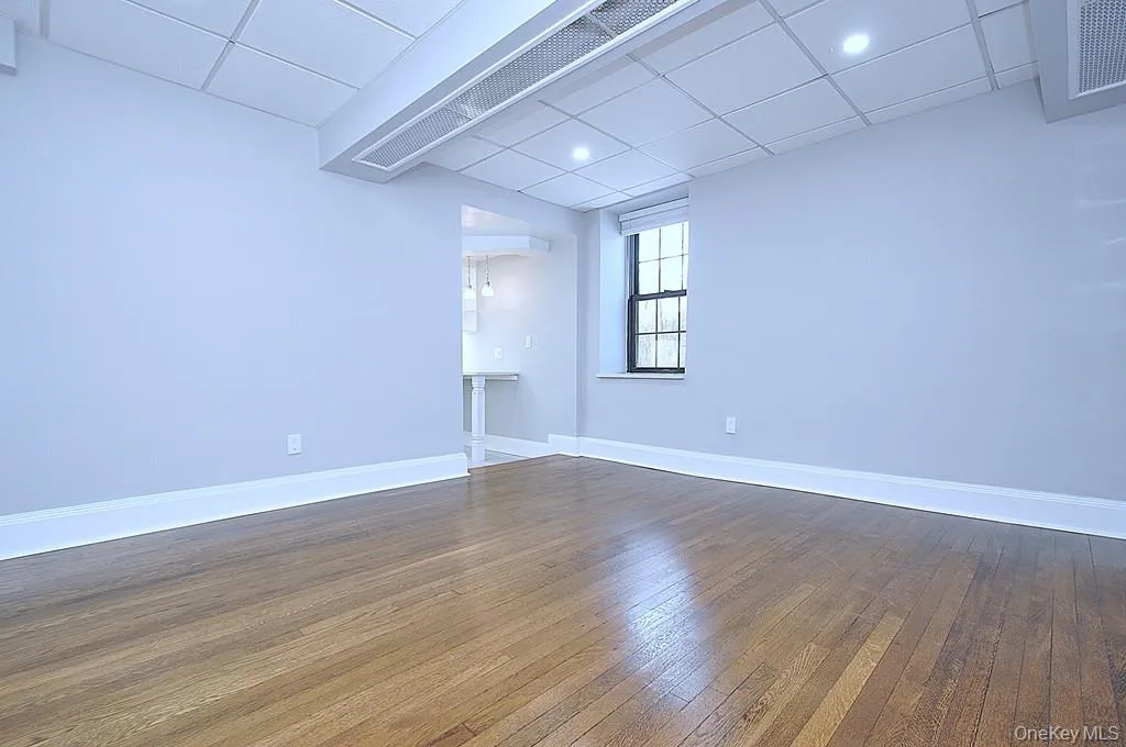 Fully renovated Living space has refinished hardwood floors, fresh paint and overhead lighting. The room is approx 13'-6" x 13". Fully renovated Living space has refinished hardwood floors, fresh paint and overhead lighting. The room is approx 13'-6" x 13".