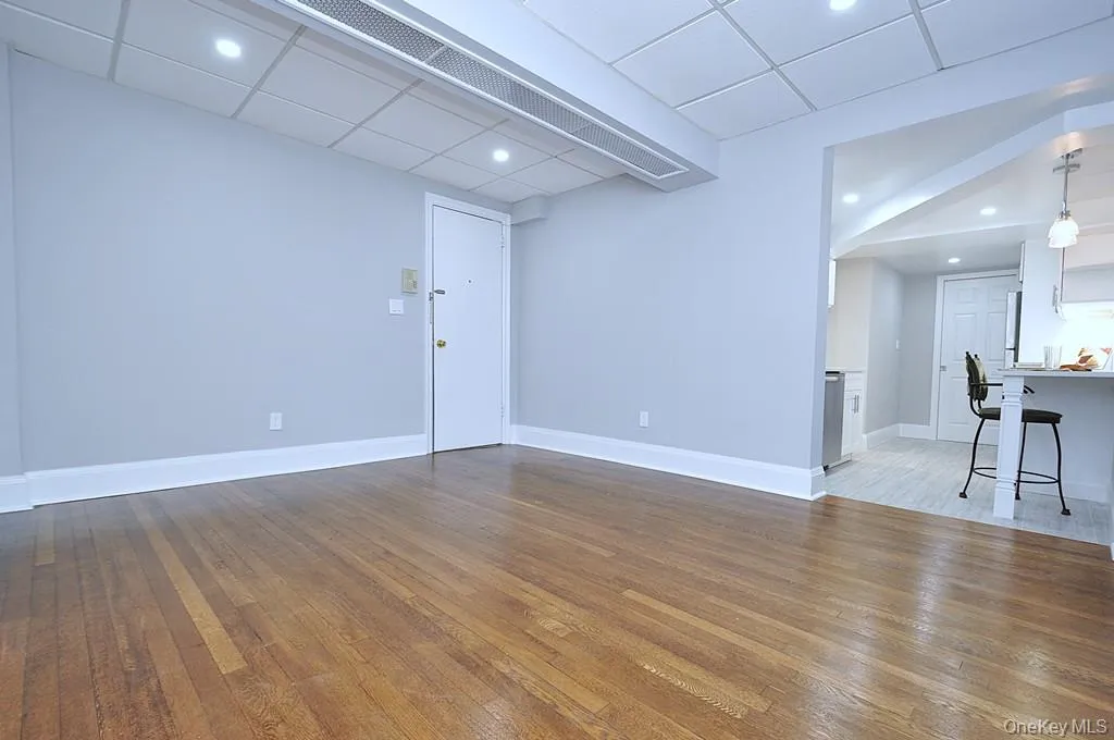Fully renovated Living space has refinished hardwood floors, fresh paint and overhead lighting. The room is approx 13'-6" x 13". Fully renovated Living space has refinished hardwood floors, fresh paint and overhead lighting. The room is approx 13'-6" x 13".