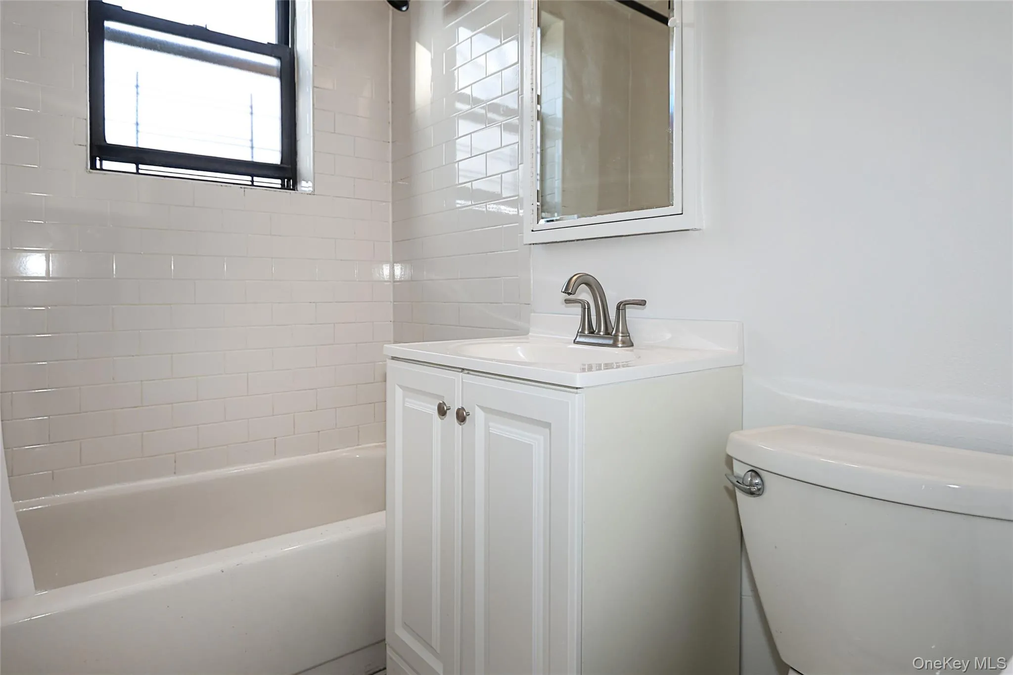 Bathroom featuring vanity and shower / bathtub combination Bathroom featuring vanity and shower / bathtub combination