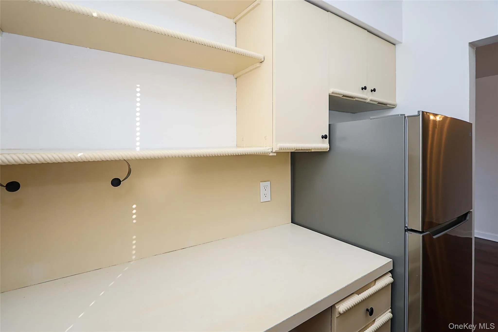 Kitchen with light countertops and freestanding refrigerator Kitchen with light countertops and freestanding refrigerator