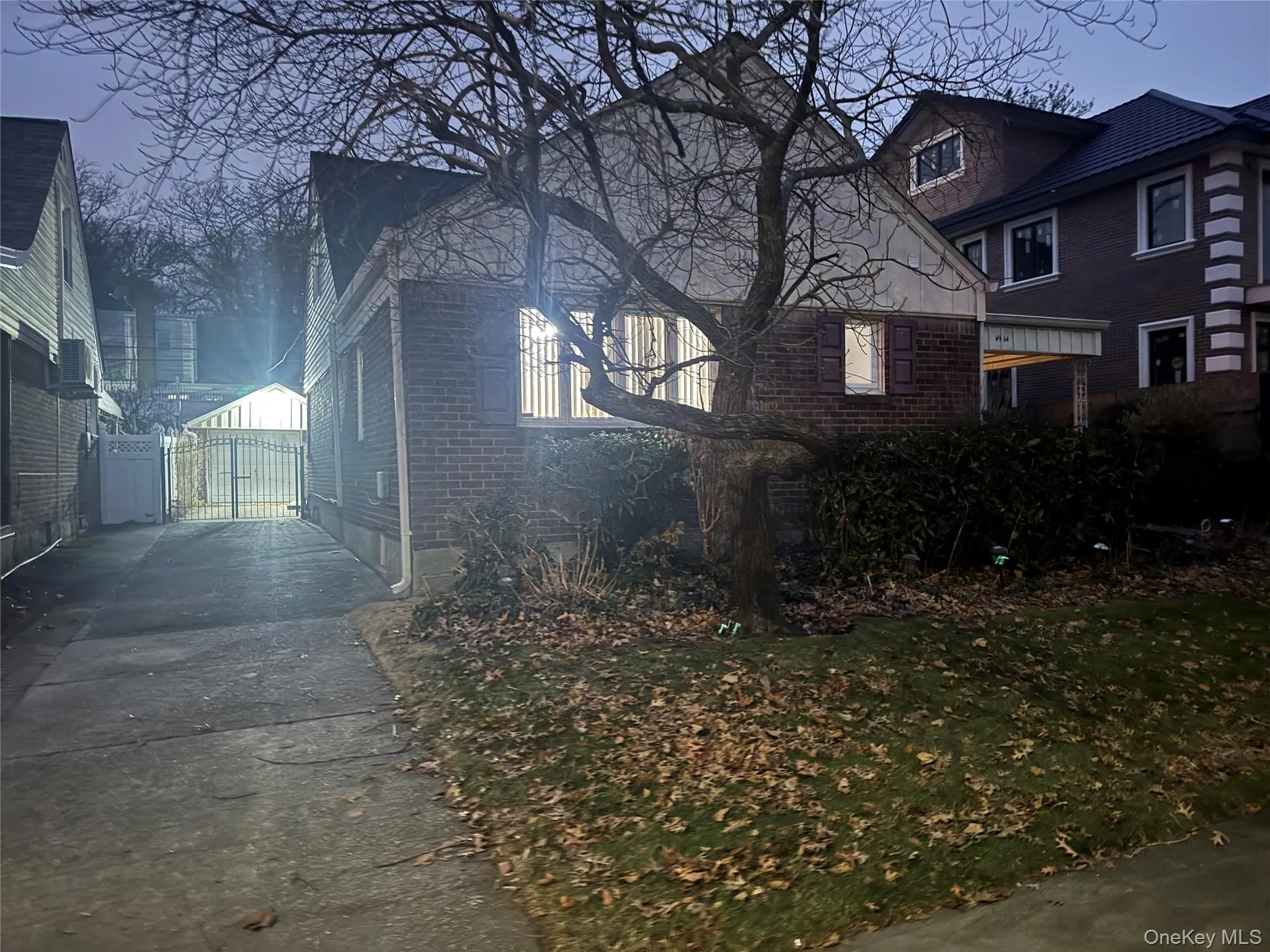 View of home's exterior featuring a gate and brick siding View of home's exterior featuring a gate and brick siding