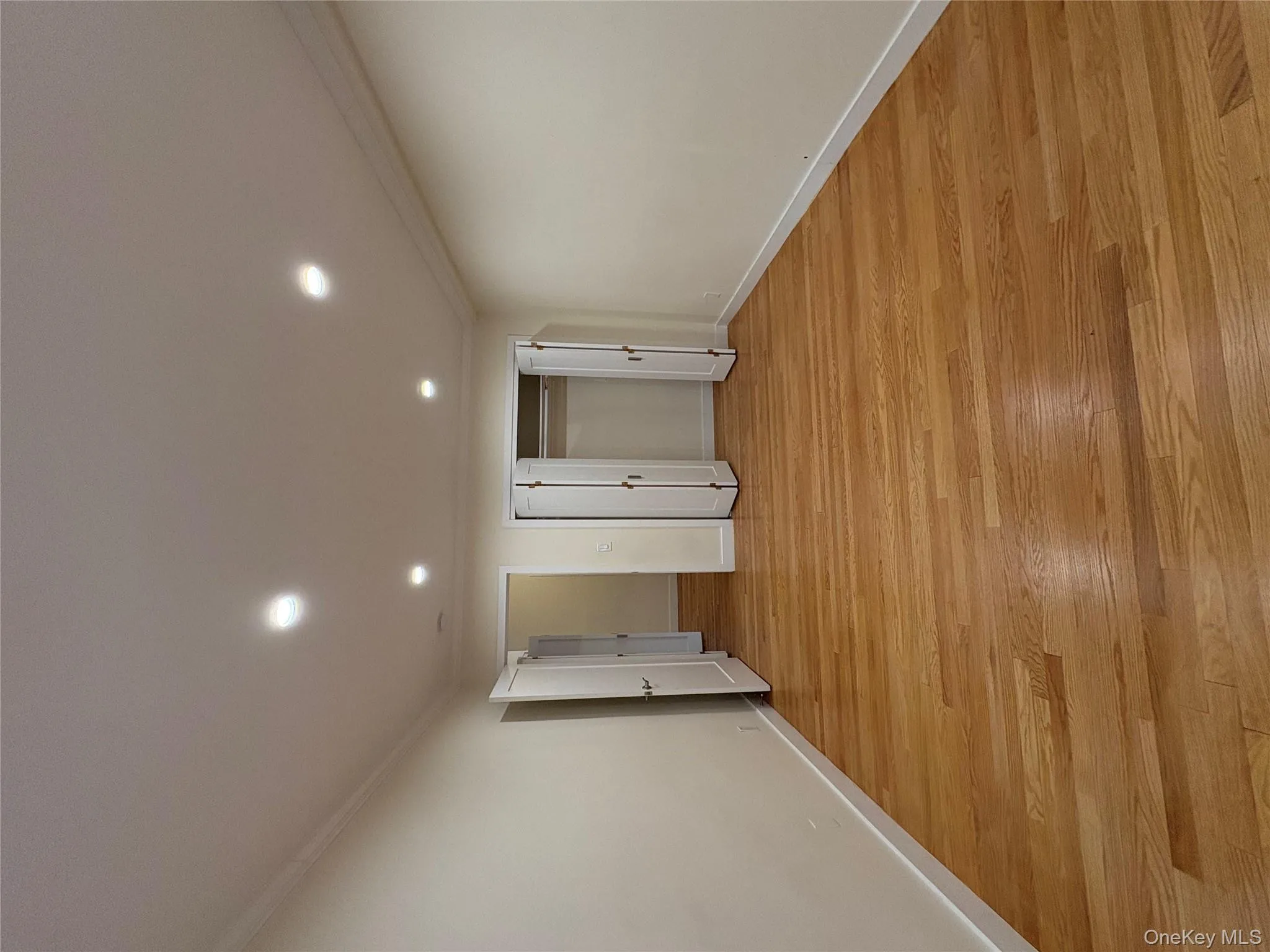 Unfurnished bedroom featuring recessed lighting, light wood-type flooring, ornamental molding, and a closet Unfurnished bedroom featuring recessed lighting, light wood-type flooring, ornamental molding, and a closet