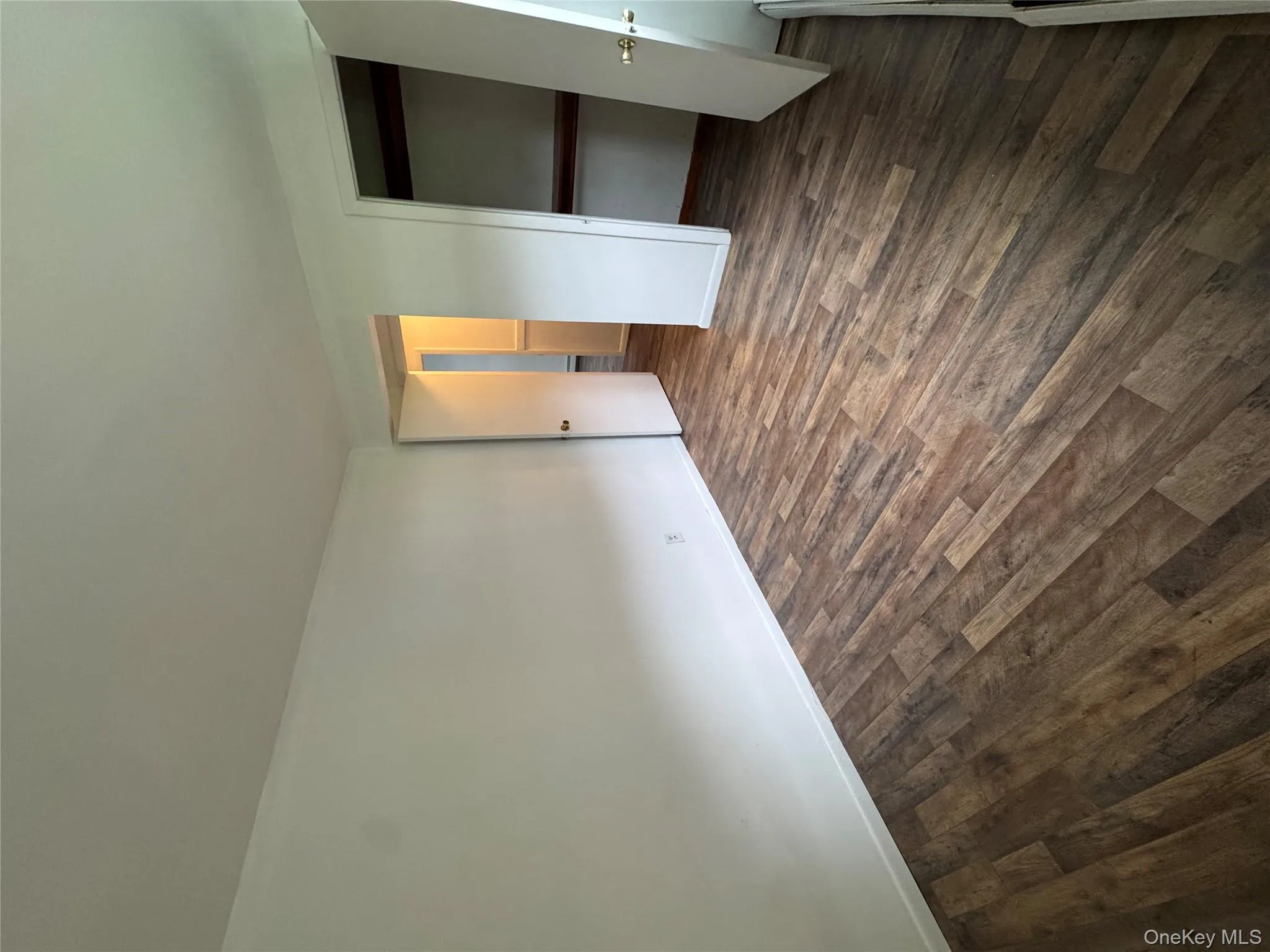 Unfurnished bedroom featuring dark wood-type flooring and a closet Unfurnished bedroom featuring dark wood-type flooring and a closet