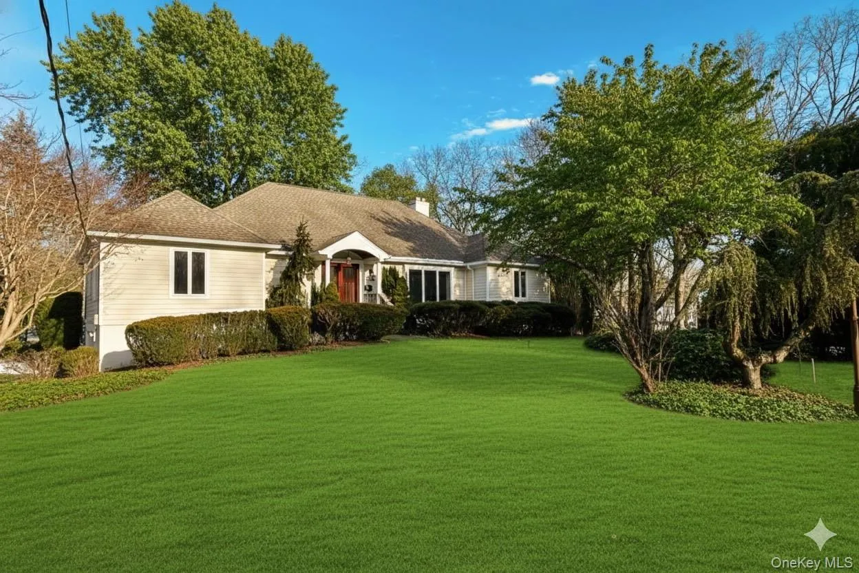 Summer view of home featuring a front virtual greenery Summer view of home featuring a front virtual greenery