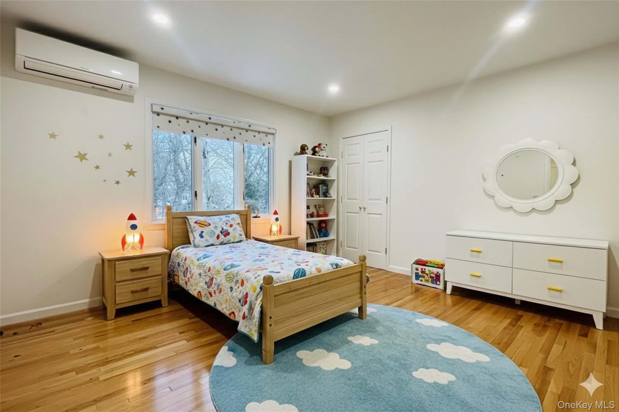 Bedroom virtually staged featuring light wood-style floors, an AC wall unit, and recessed lighting Bedroom virtually staged featuring light wood-style floors, an AC wall unit, and recessed lighting