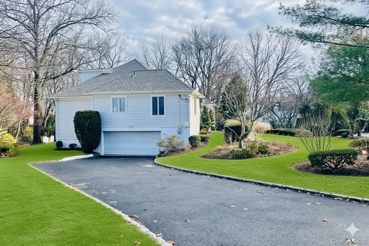 View of property exterior featuring driveway, a shingled roof, a yard, and a garage View of property exterior featuring driveway, a shingled roof, a yard, and a garage
