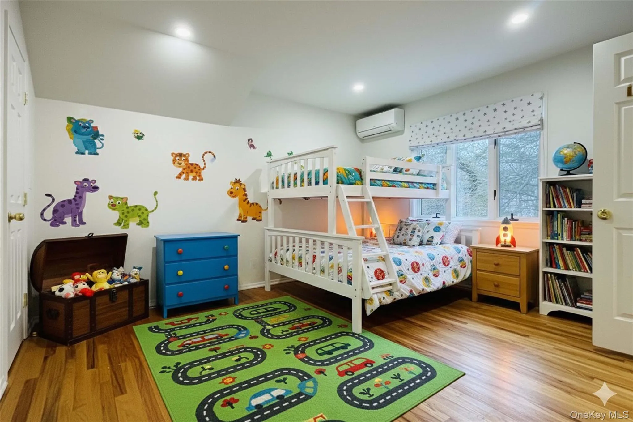 Bedroom virtually staged featuring light wood-style floors and an AC wall unit Bedroom virtually staged featuring light wood-style floors and an AC wall unit