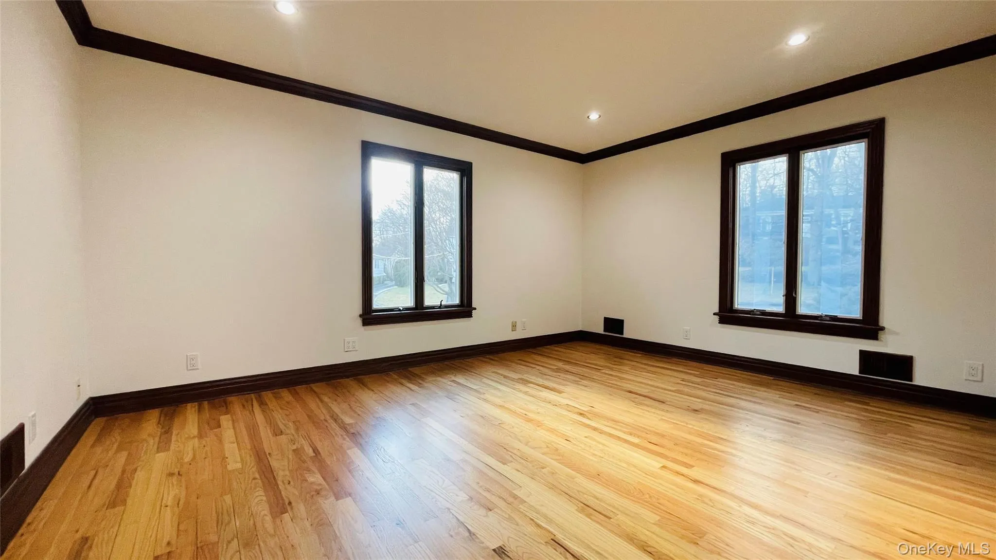 Bedroom/Office/Nursery on main level with crown molding, light wood-style floors, and recessed lighting Bedroom/Office/Nursery on main level with crown molding, light wood-style floors, and recessed lighting