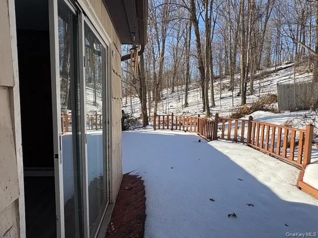 Yard covered in snow featuring a deck Yard covered in snow featuring a deck