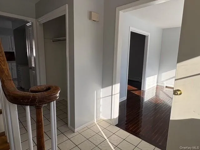 Hallway featuring light wood-type flooring and baseboards Hallway featuring light wood-type flooring and baseboards
