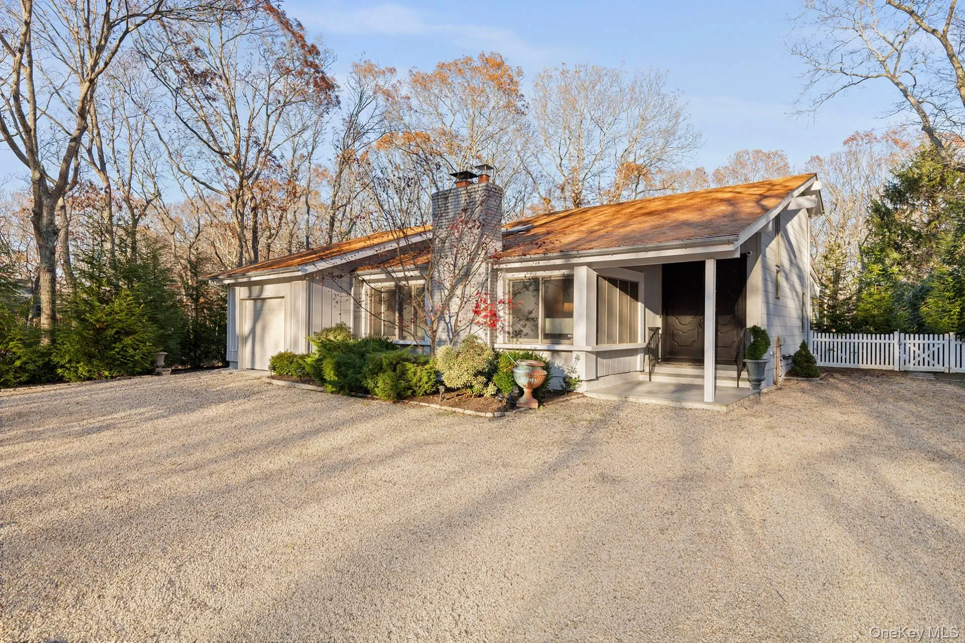 View of front of house with a chimney, board and batten siding, and a patio