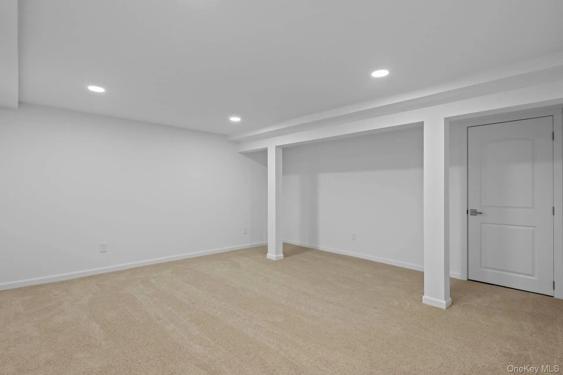 Finished basement with recessed lighting and light colored carpet