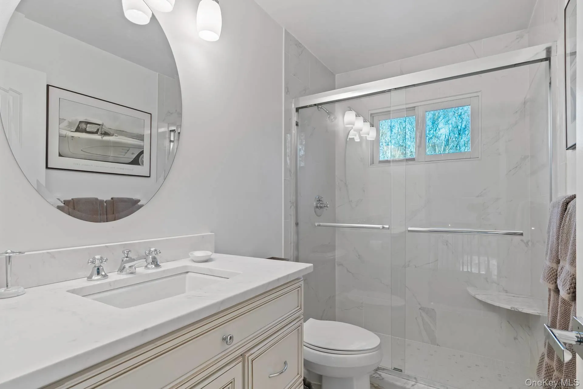 Full bathroom with a marble finish shower and vanity