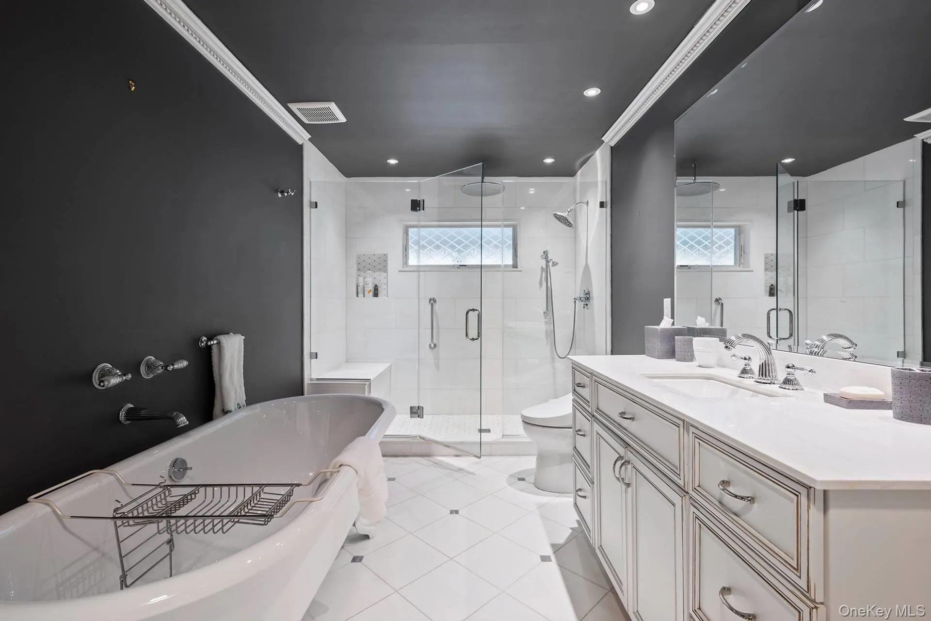 Bathroom with vanity, a soaking tub, crown molding, a stall shower, and healthy amount of natural light