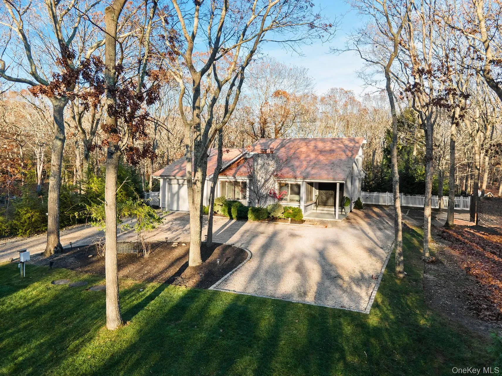 View of front of house with a sunroom and roof with shingles