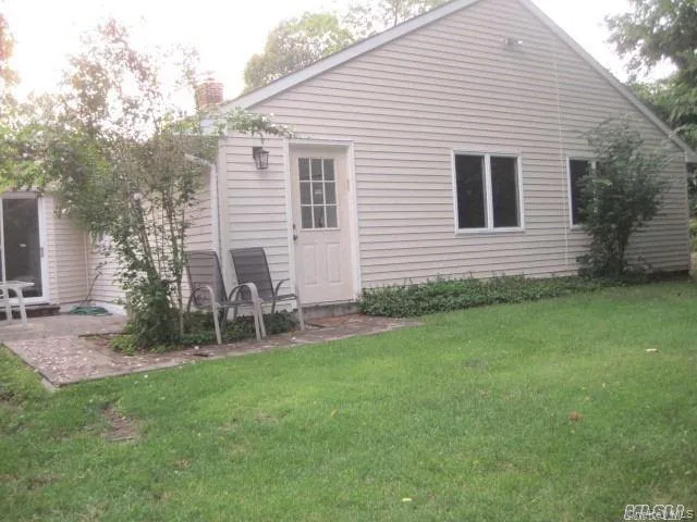 Rear view of property featuring a yard, a chimney, and a patio Rear view of property featuring a yard, a chimney, and a patio