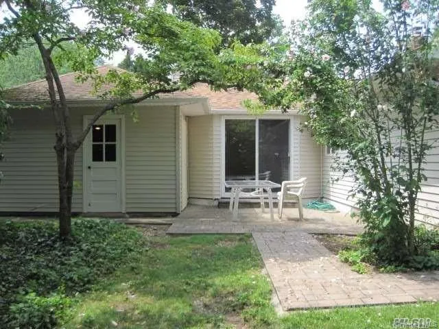 Rear view of house with a patio area Rear view of house with a patio area