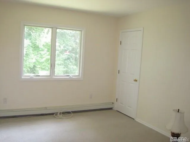Empty room with a baseboard heating unit Empty room with a baseboard heating unit