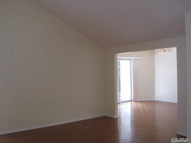 Empty room with a chandelier and baseboards Empty room with a chandelier and baseboards