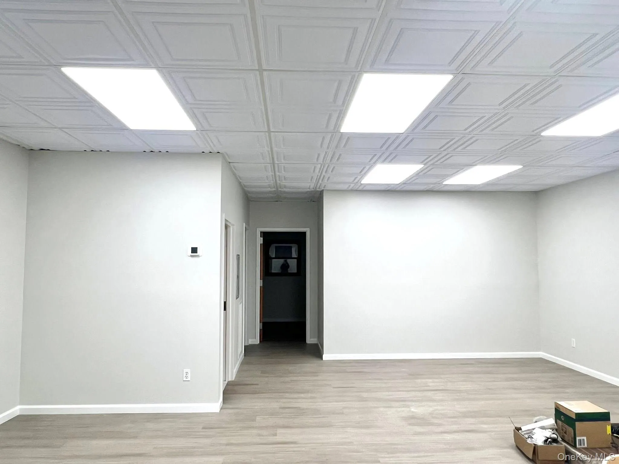 Unfurnished room with light wood finished floors and baseboards Unfurnished room with light wood finished floors and baseboards