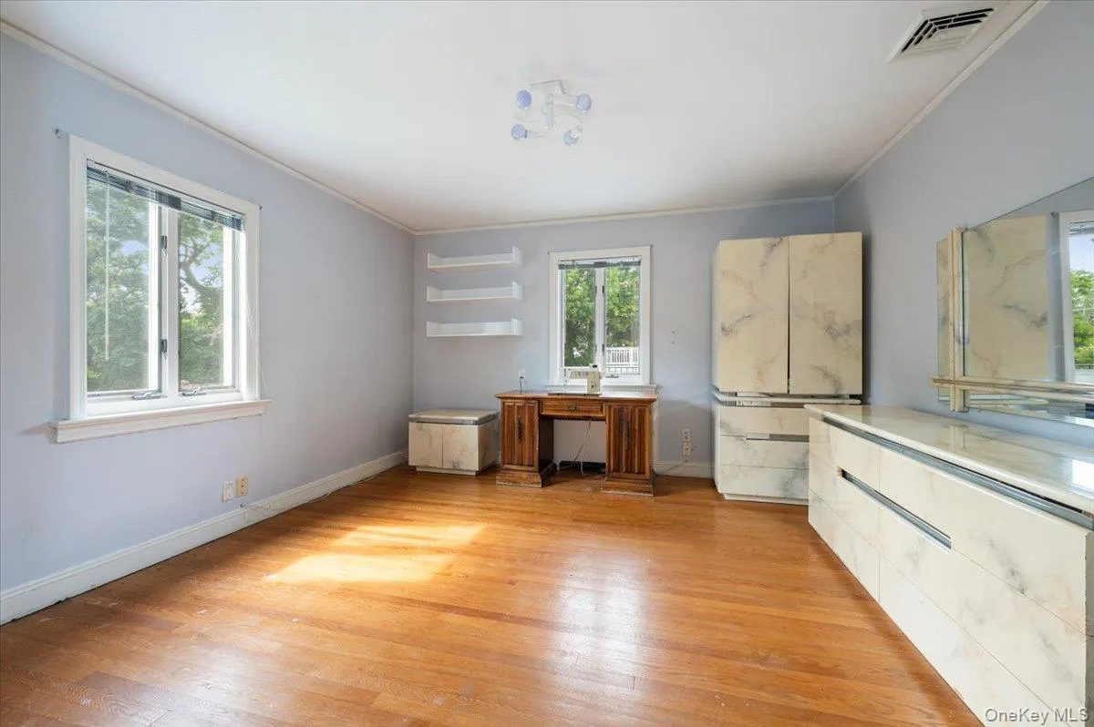 Unfurnished office with light wood-style floors and crown molding Unfurnished office with light wood-style floors and crown molding