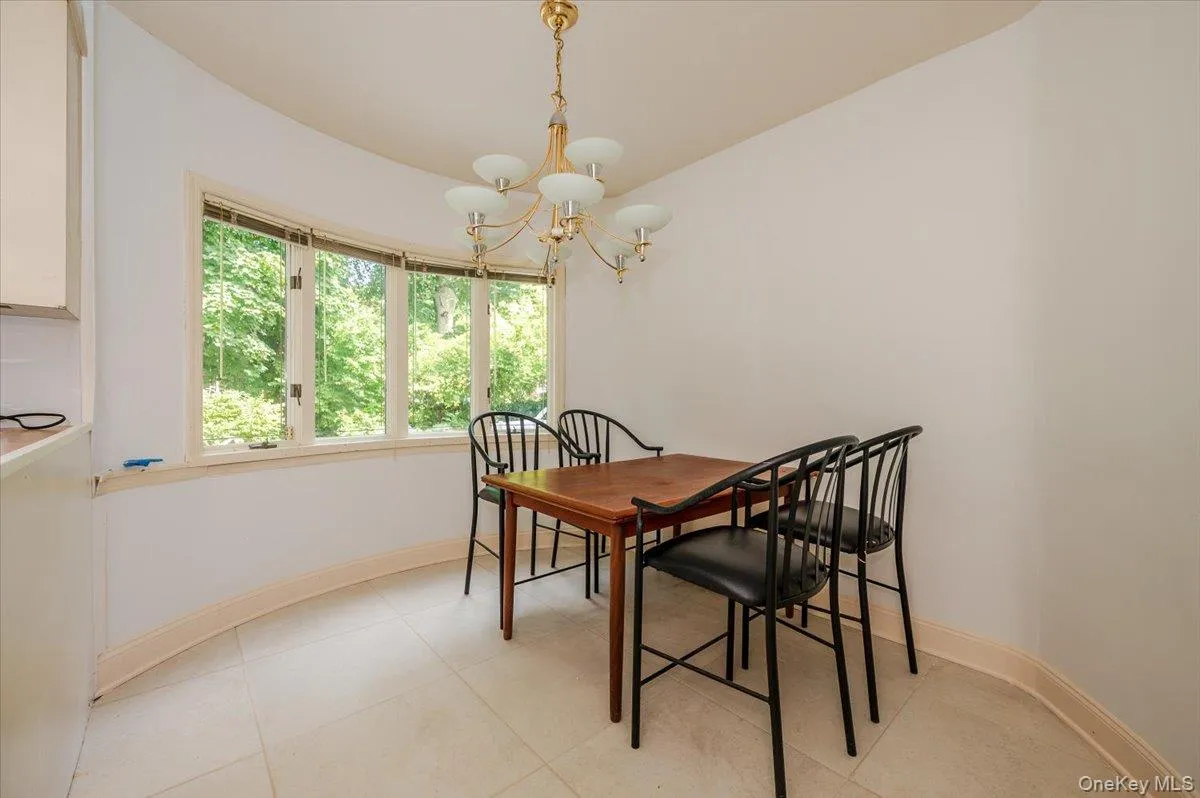 Dining area featuring a chandelier and light tile patterned floors Dining area featuring a chandelier and light tile patterned floors