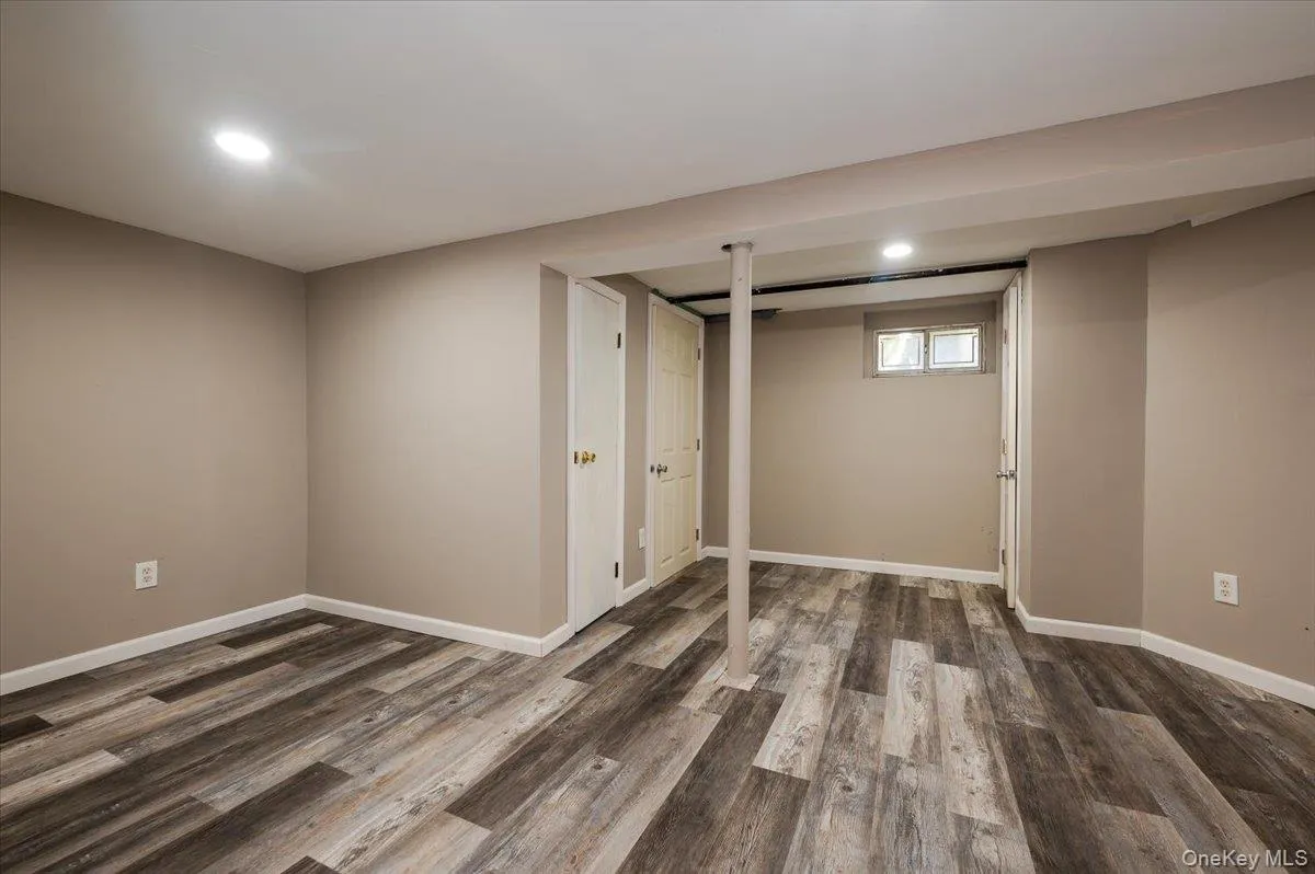 Below grade area with dark wood-style floors and recessed lighting Below grade area with dark wood-style floors and recessed lighting