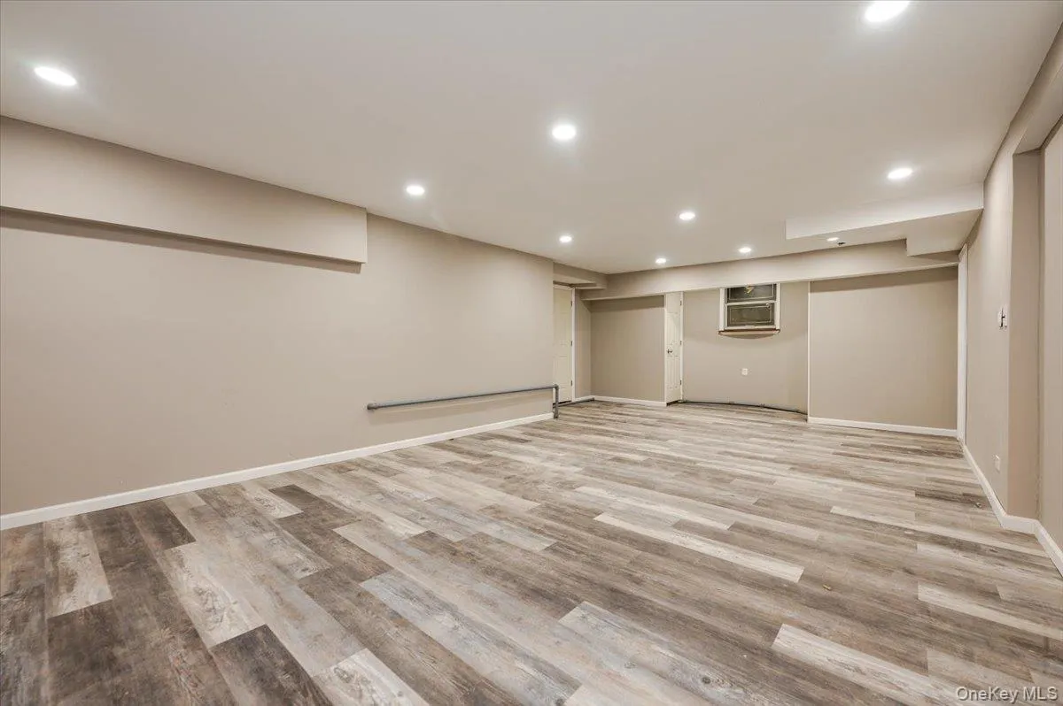 Finished basement with recessed lighting and light wood-type flooring Finished basement with recessed lighting and light wood-type flooring