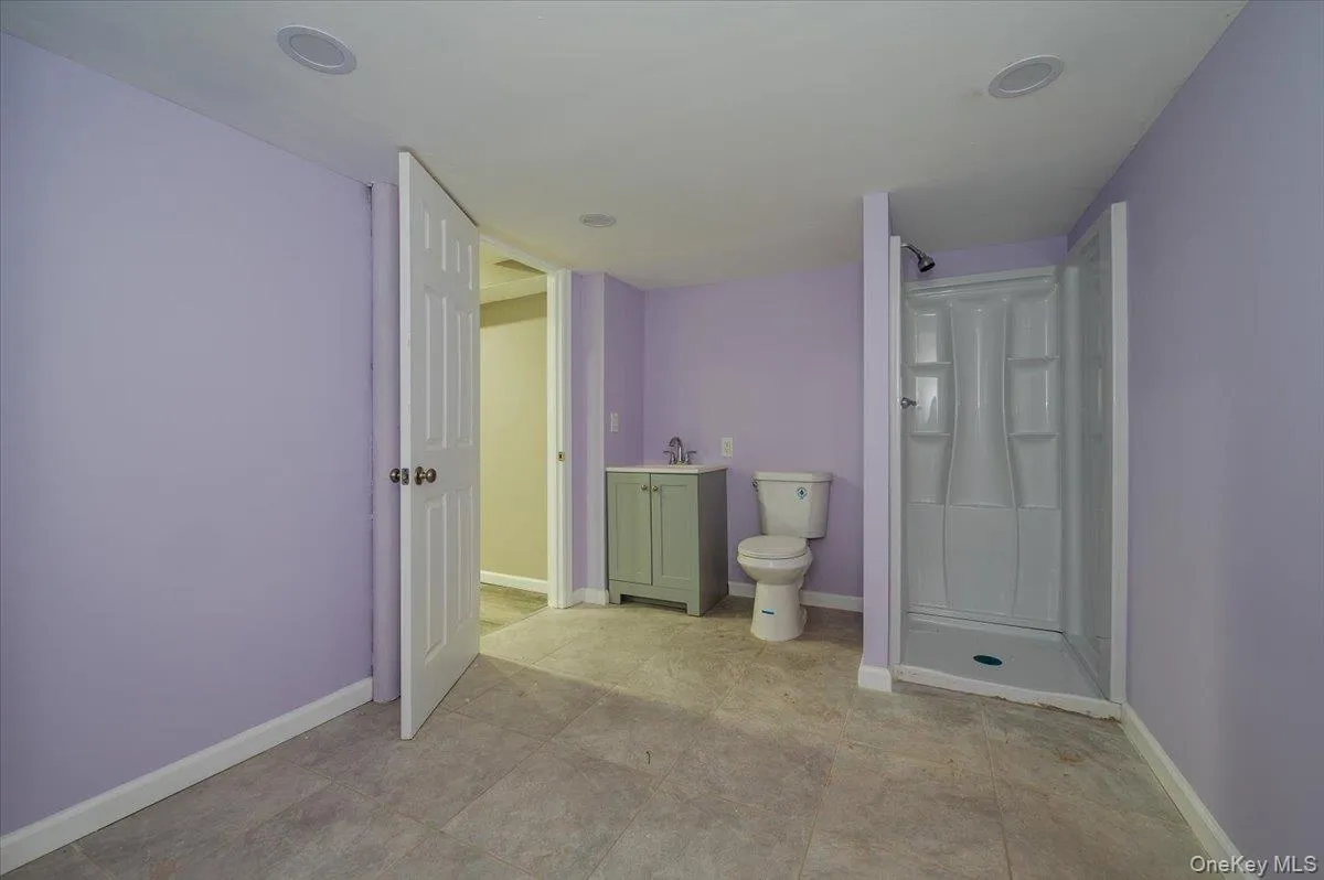 Bathroom with vanity and a shower stall Bathroom with vanity and a shower stall