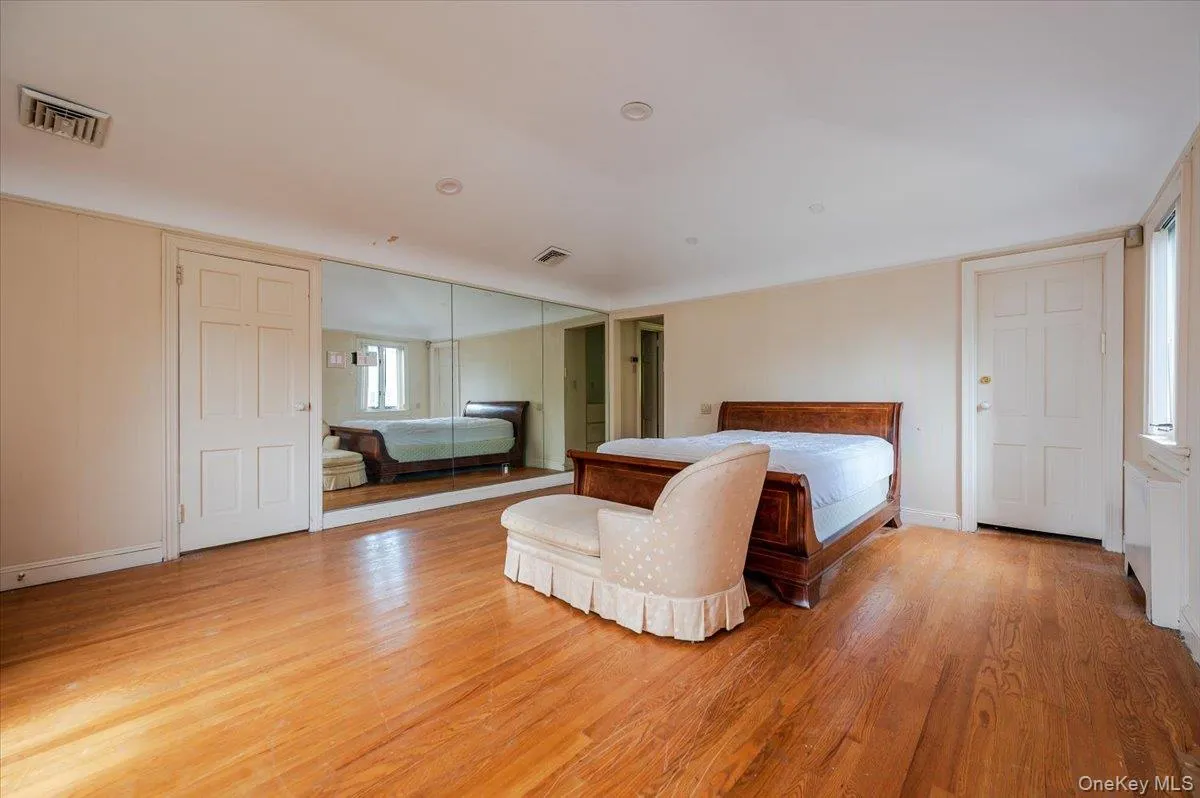 Bedroom featuring light wood-style floors and baseboards Bedroom featuring light wood-style floors and baseboards