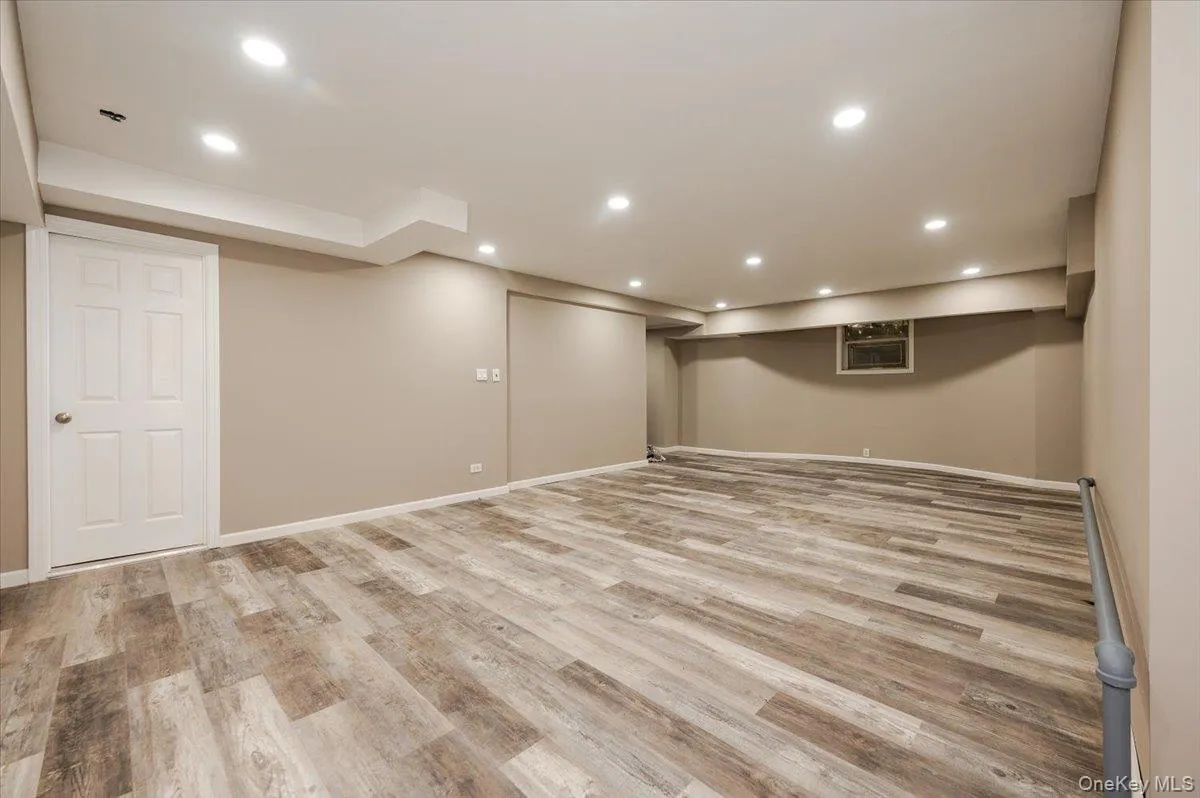 Finished basement with recessed lighting and light wood finished floors Finished basement with recessed lighting and light wood finished floors