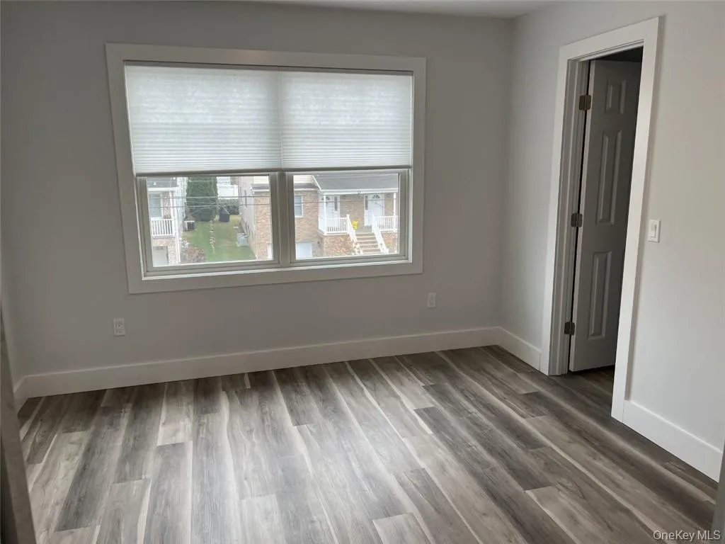 Unfurnished room featuring baseboards and light wood finished floors Unfurnished room featuring baseboards and light wood finished floors
