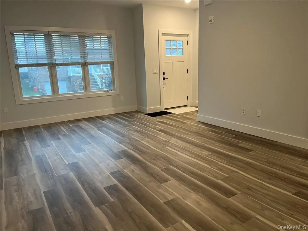 Entryway with dark wood-type flooring and baseboards Entryway with dark wood-type flooring and baseboards